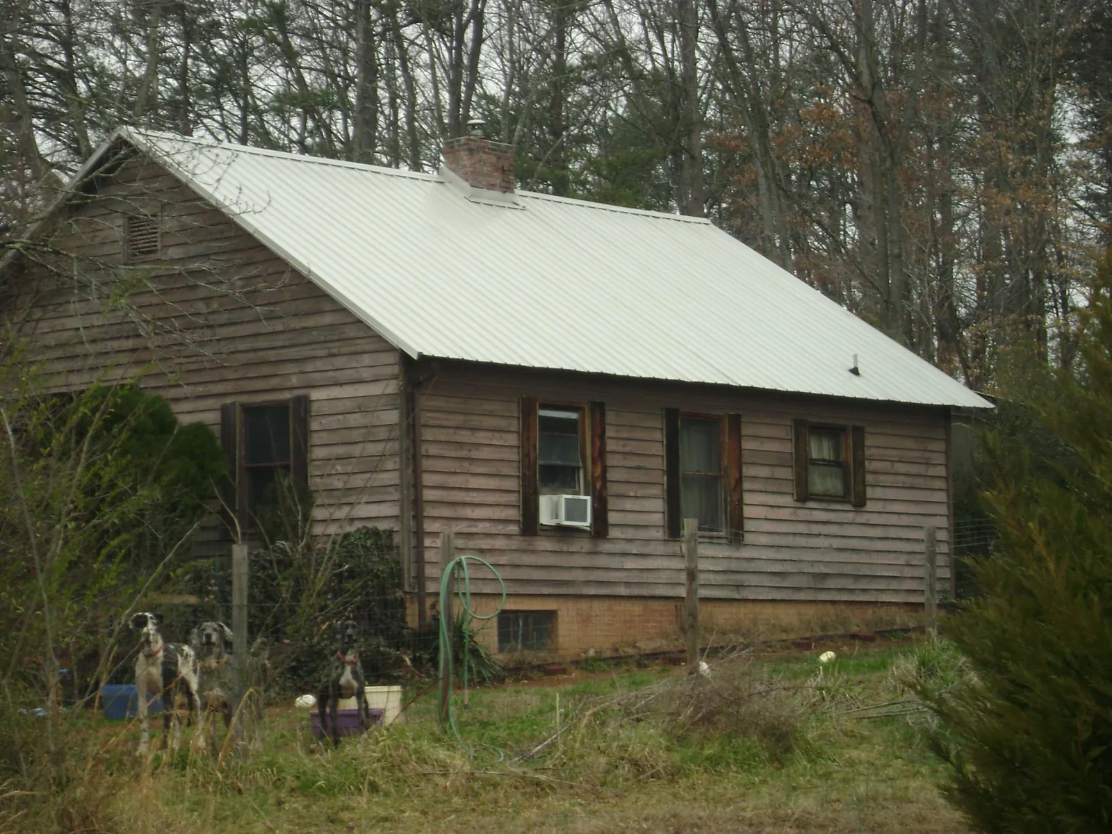 White metal roof on an old wood sided farmhouse, from a Metal Roof Installation job in Sisters